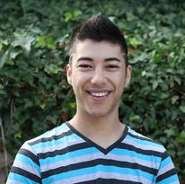 A headshot of Zack Hong, a half white, half Asian, queer, non-disabled man who smiles at the camera.